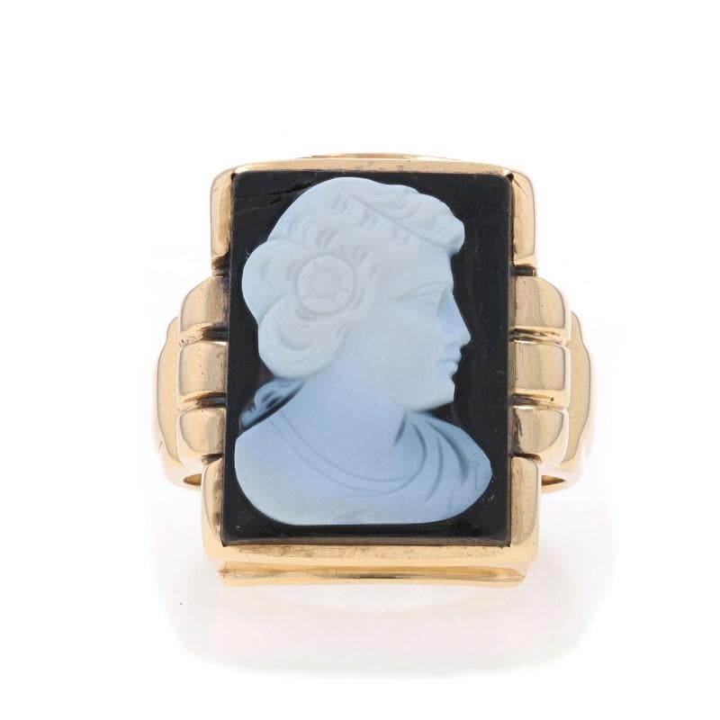 Size: 10
Sizing Fee: Up 1 size for $40 or Down 1 size for $40

Era: Art Deco
Date: 1920s - 1930s

Metal Content: 10k Yellow Gold

Stone Information
Natural Hardstone / Banded Agate
Cut: Carved Cameo
Color: Black & White
Size: 19.9mm x 15.1mm

Style: