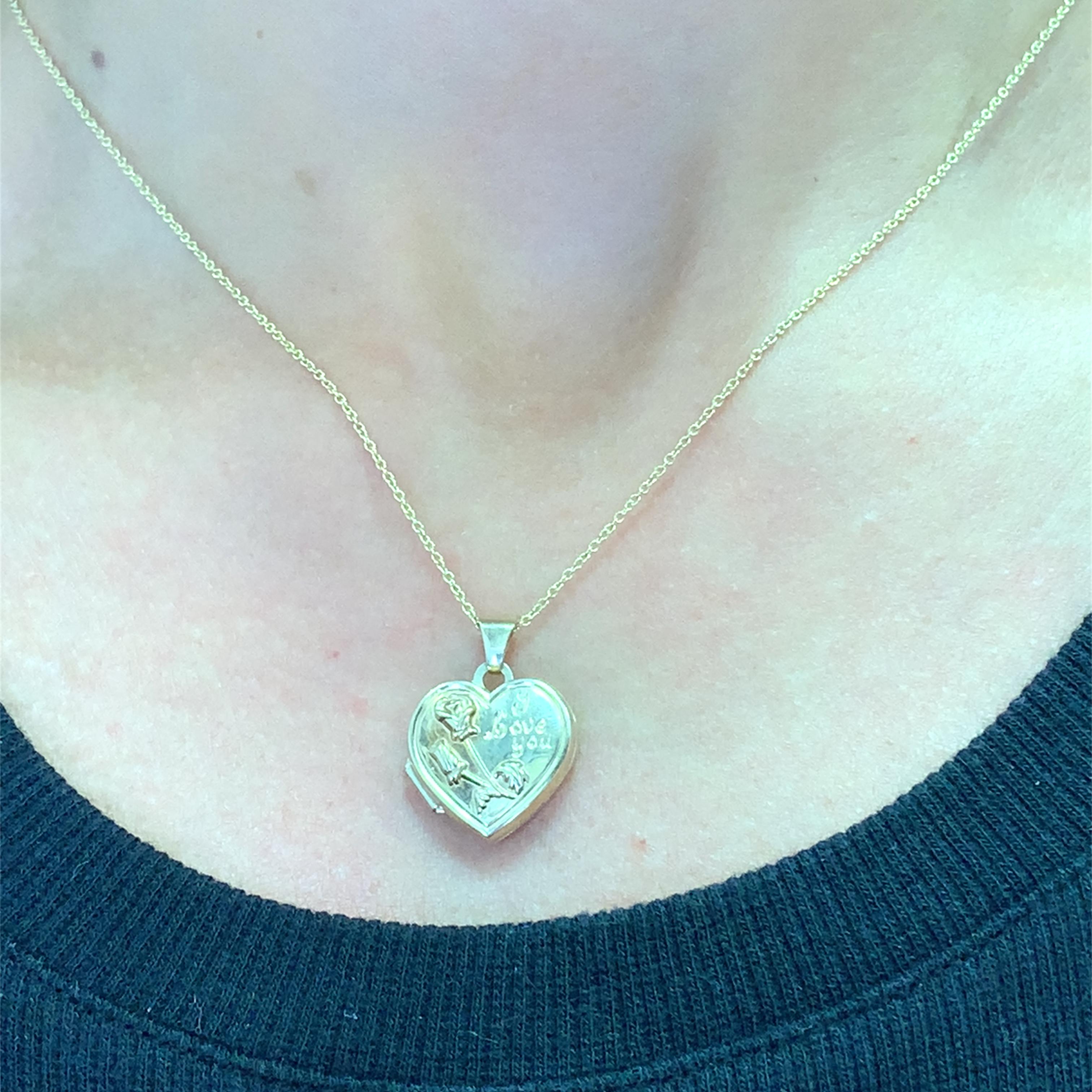 This romantic yellow gold heart locket necklace is the perfect sentimental treasure. The polished locket features a delicate rose and 'I love you' engraving. A meaningful keepsake, this necklace adds a touch of heartfelt charm to any ensemble. Ideal