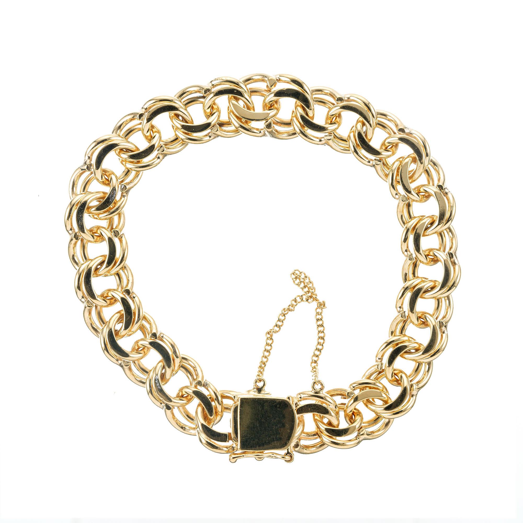 1950'd, 8 inch long heavy double spiral link charm bracelet in 14k yellow gold. 

14k yellow gold 
Stamped: 14k
49.5 grams
Chain: 8 Inches
Width: 12.26mm
Thickness/depth: 5.5mm

