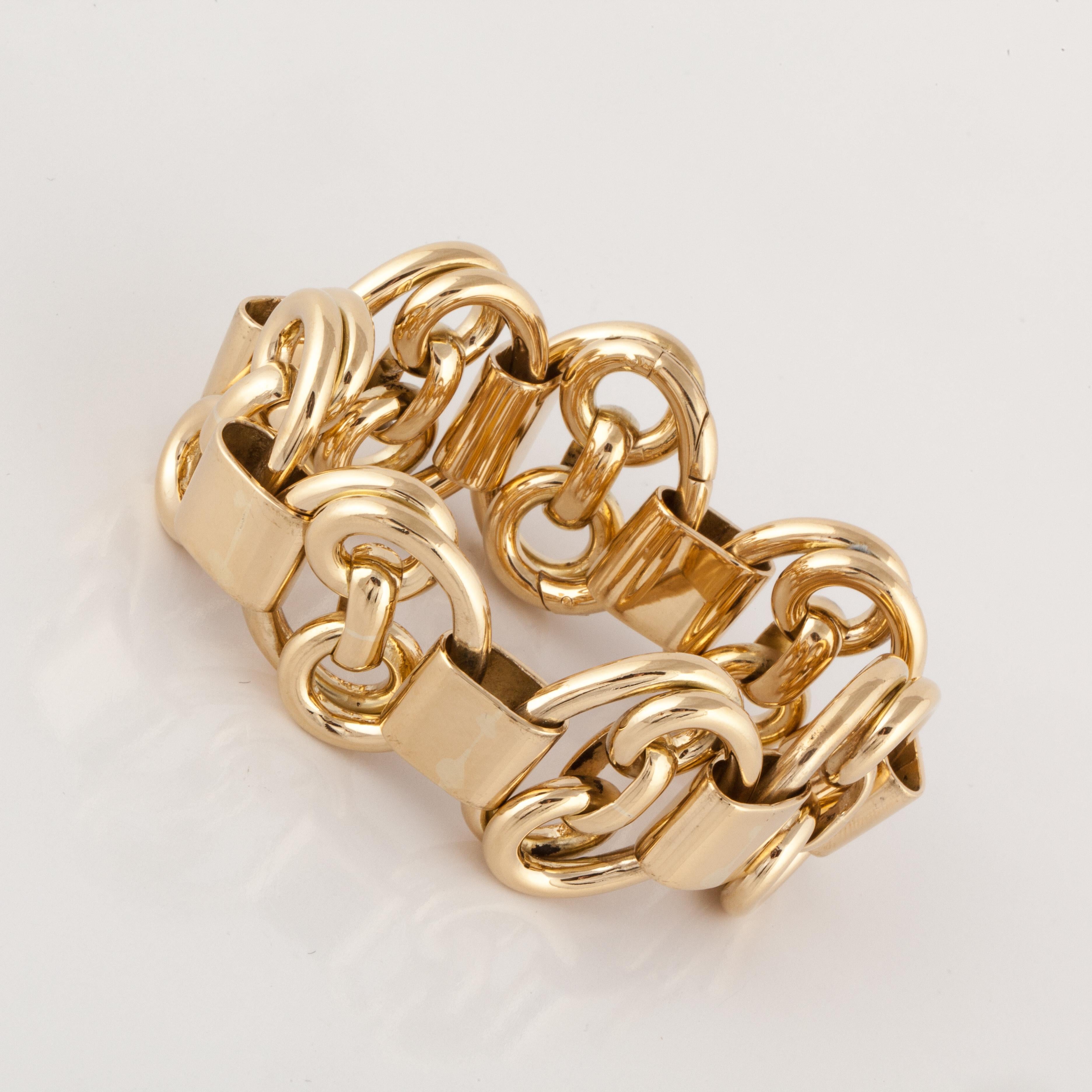 18K yellow gold heavy link bracelet.  The links are double swirls with flat spacers.  The catch is almost invisible in this high quality piece.  Measures 8 inches long and 1 3/16 inches wide.  