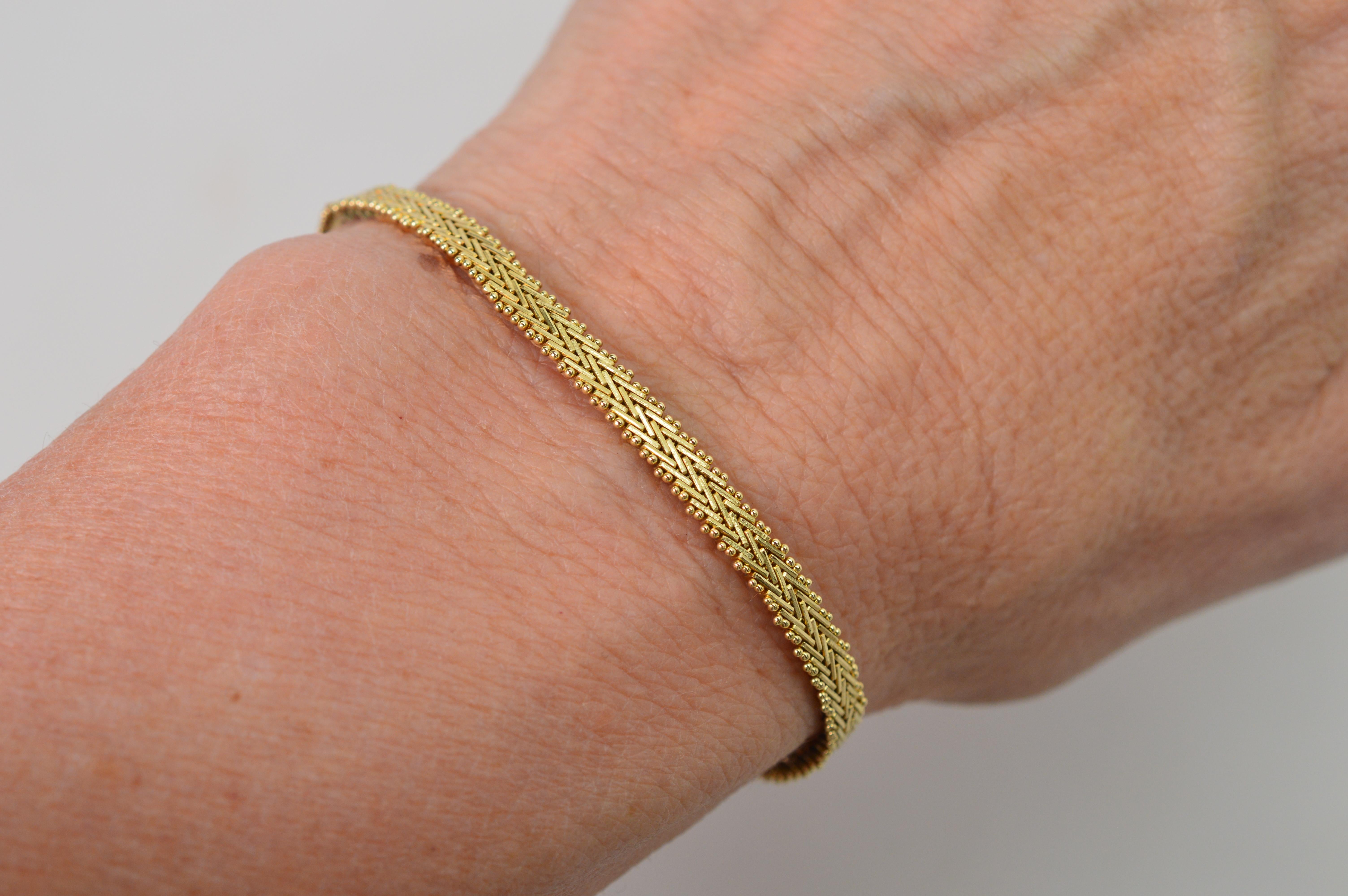 Sleek and slim, this classic herringbone pattern bracelet in fourteen carat 14k yellow gold is a jewelry wardrobe work horse. Pretty to wear on its own with plenty of shine from it textured pattern plus perfect for stacking with other jewelry