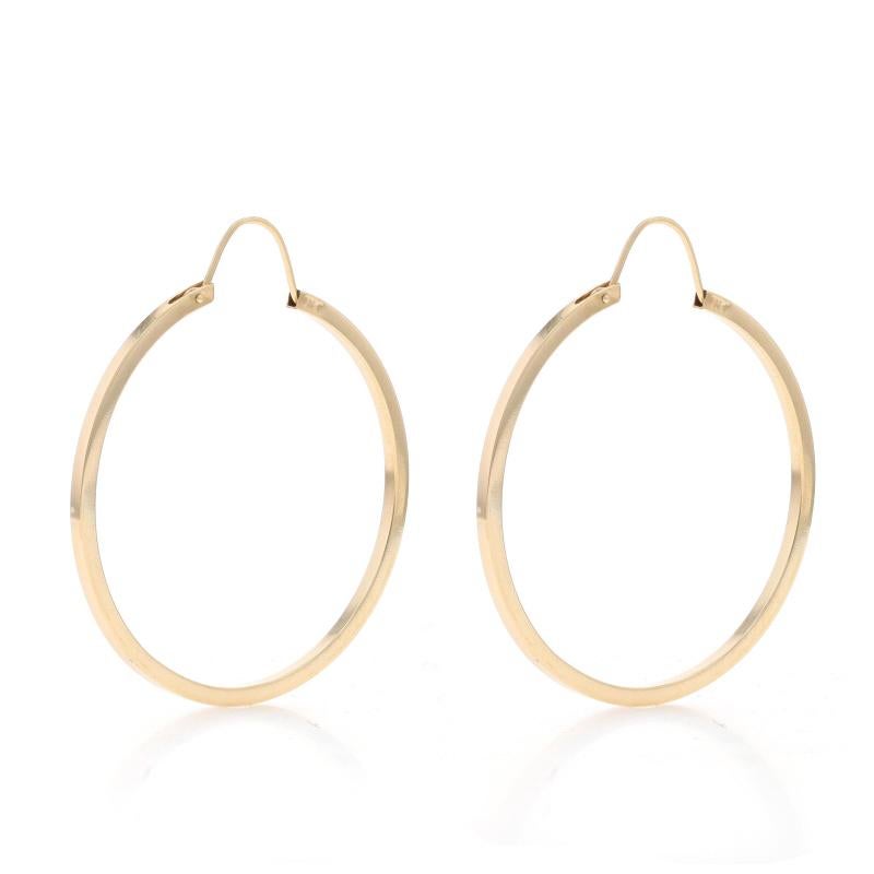 Metal Content: 14k Yellow Gold

Style: Hoop
Fastening Type: Slide Closures
Features: Hollow Construction for Comfortable, All-Day Wear

Measurements

Tall: 1 21/32