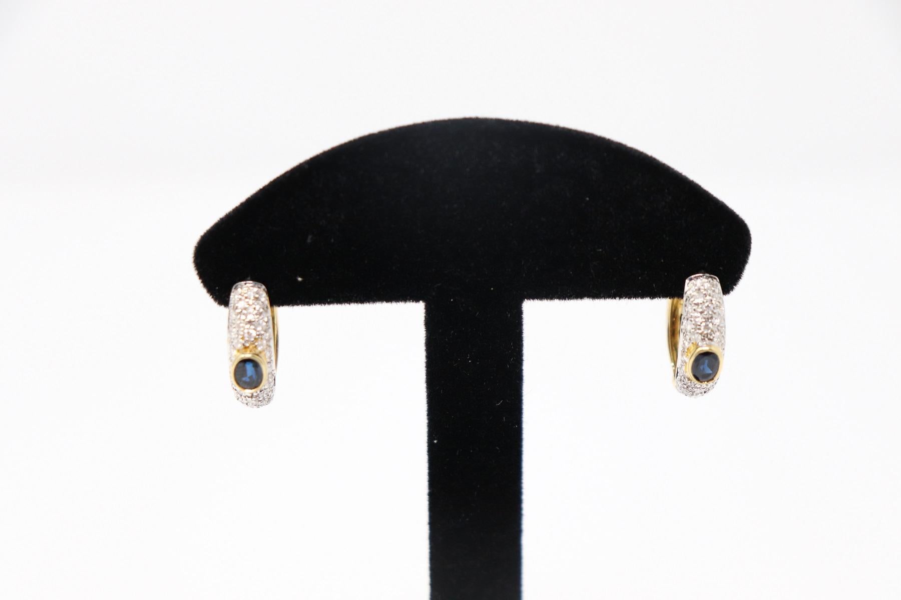 18 Karat yellow gold fashion drop earring with Central Blue Sapphire about 0.45 Carats and brilliant cut diamonds total about 0.90 Carats. 
Total weight: about 6.90 g.
New contemporary jewelry. Produced in the famous Italian city of gold Valenza.