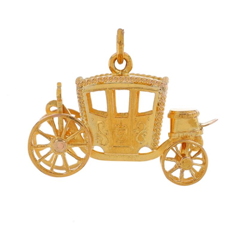 Metal Content: 18k Yellow Gold

Theme: Horse-Drawn Carriage, Covered Transportation
Features: Etched Detailing & Moving Wheels

Measurements
Tall (from stationary bail): 25/32