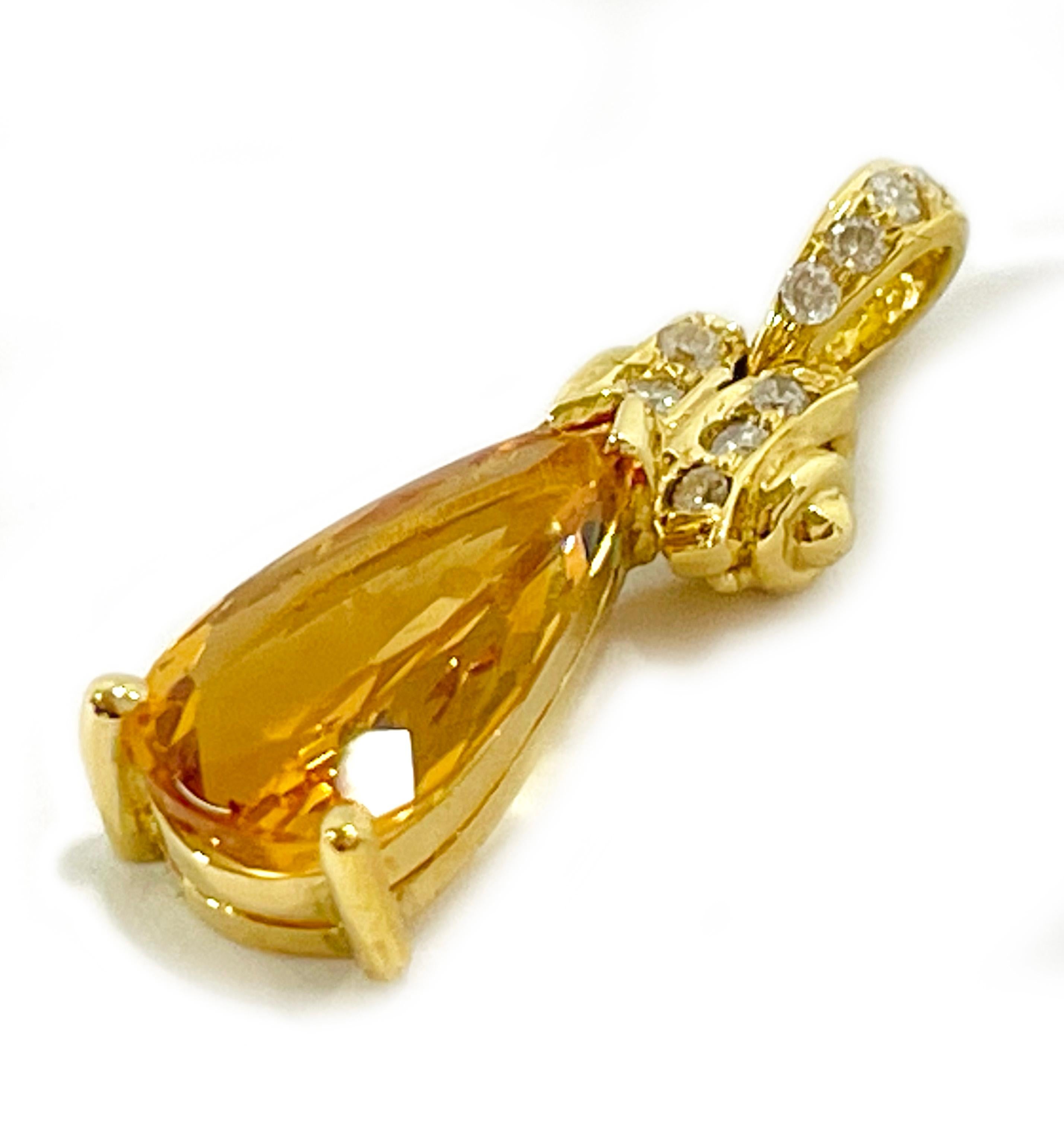 18 Karat Yellow Gold Imperial Topaz Diamond Pendant. The beautiful pendant features a pear-shaped Imperial Topaz on a basket setting with a total of ten round diamonds set above the basket and on the bail. The topaz measures 13.16 x 6.62mm for a