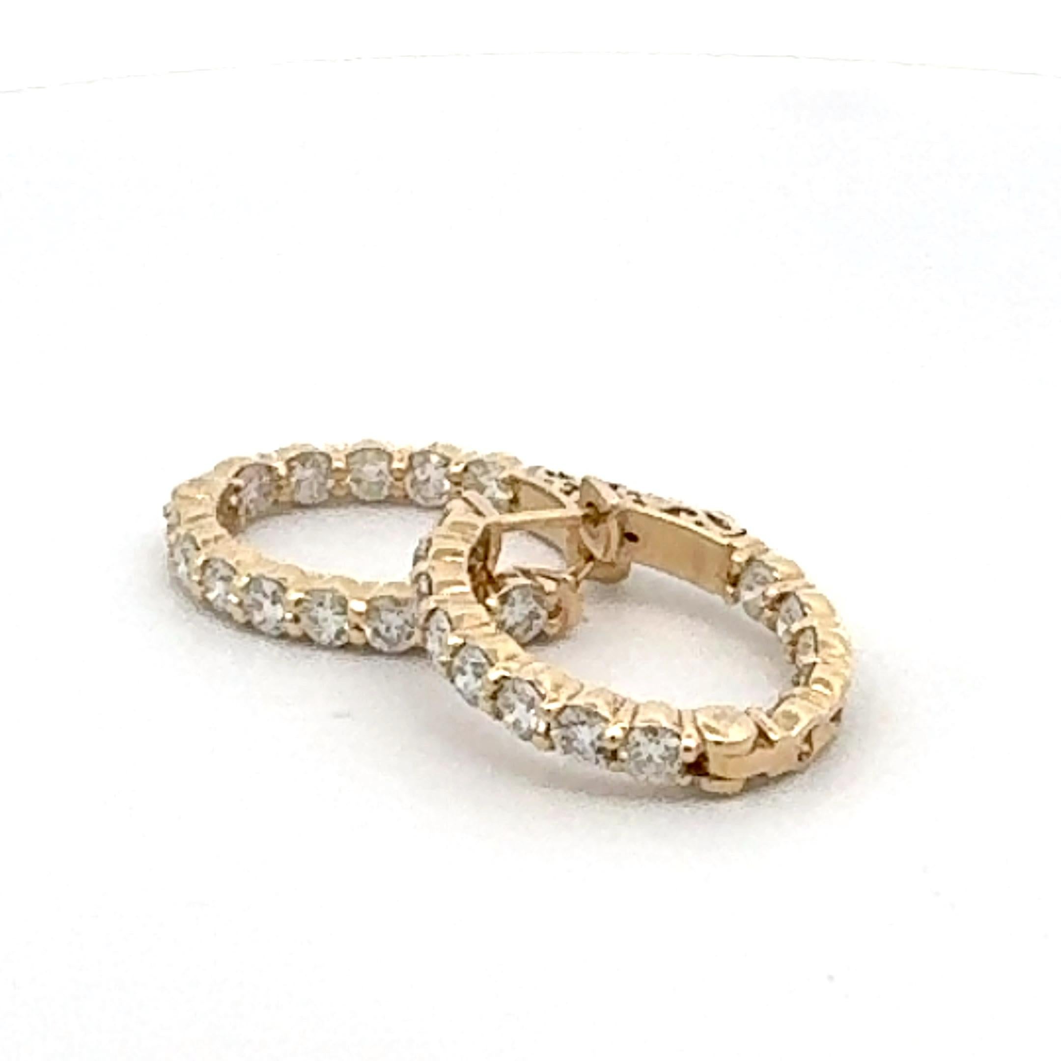  This 14k yellow gold diamond hoop earring is a versatile and stunning accessory that can be worn for various occasions, from daily wear to special events, combining elegance and timeless, This hoop earring is circular, encircling the earlobe, and