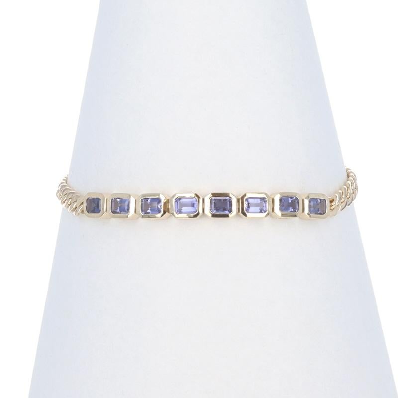 Metal Content: 14k Yellow Gold

Stone Information

Natural Iolite
Carat(s): 1.28ctw
Cut: Emerald

Total Carats: 1.28ctw

Chain Style: Curb
Bracelet Style: Eight-Stone
Fastening Type: Lobster Claw Clasp
Features: Bezel Set Stones

Measurements

Chain