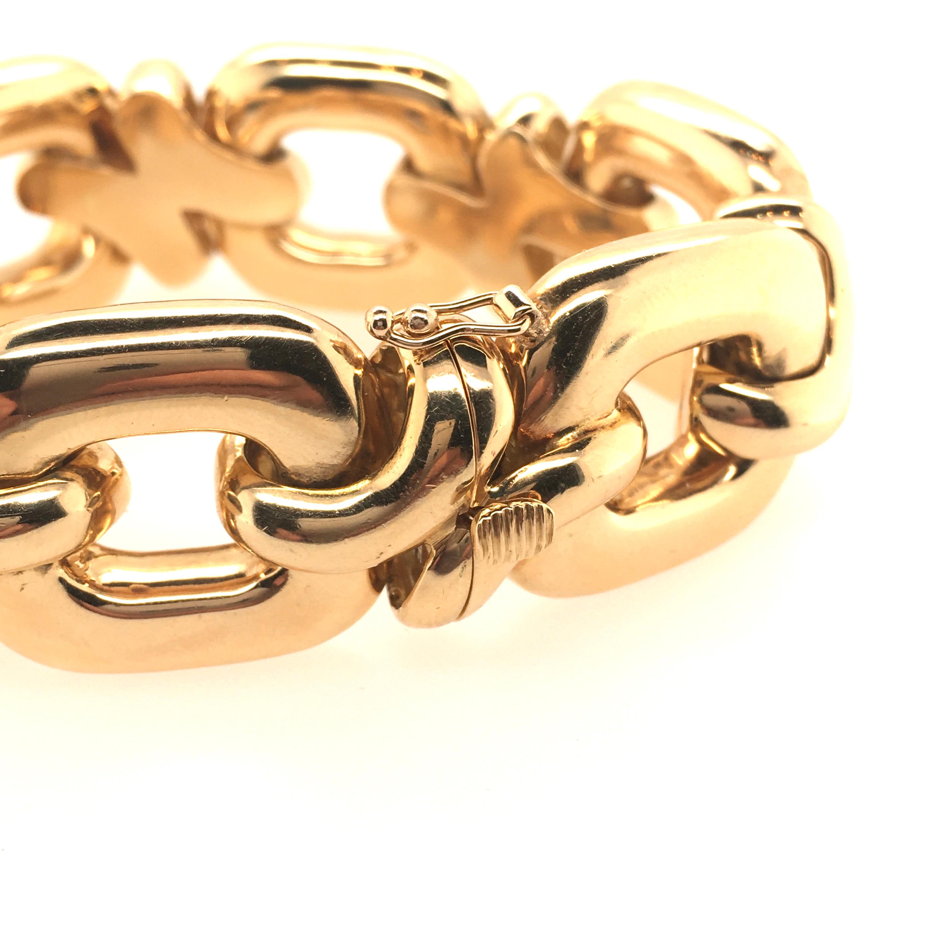 An 18 karat yellow gold bracelet. Italian. Circa 1970. Designed as polished oval links, spaced by scrolling links. Length is approximately 7 1/4 inches, gross weight is approximately 88.1 grams. With Italian assay marks. 