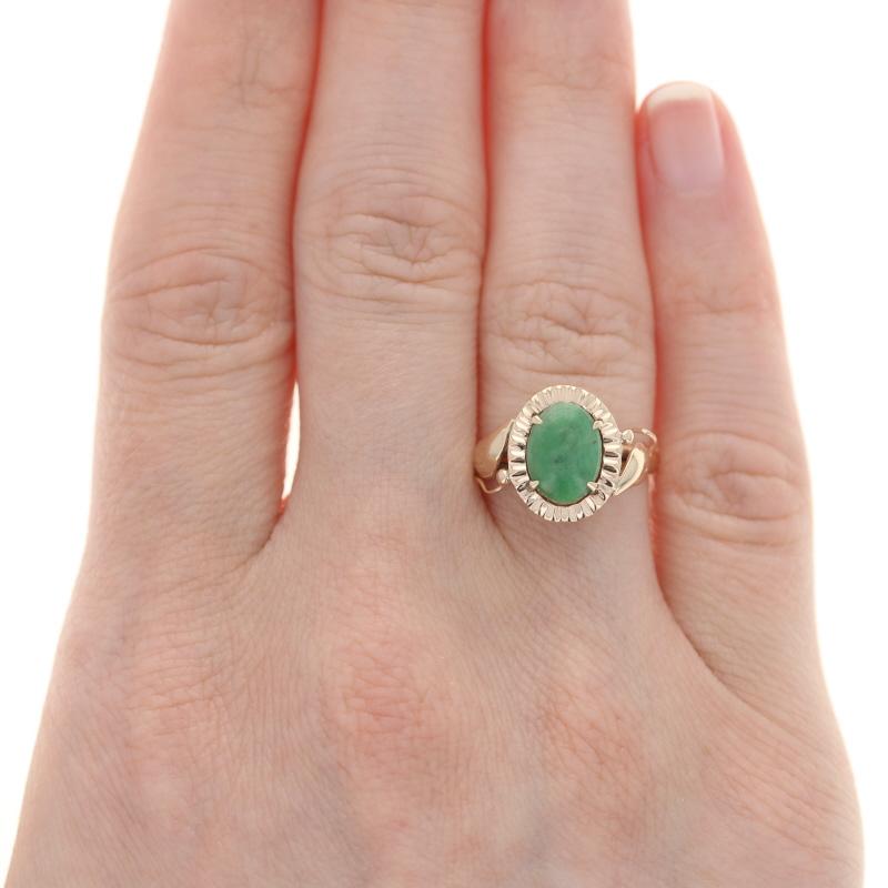 Size: 6 1/4
Sizing Fee: Down 2 sizes for $30 or up 2 sizes for $35

Era: Vintage

Metal Content: 14k Yellow Gold

Stone Information
Genuine Jadeite
Treatment: Routinely Enhanced
Carat: 1.09ct
Cut: Oval Cabochon 
Color: Green 
Size: 9.3mm x