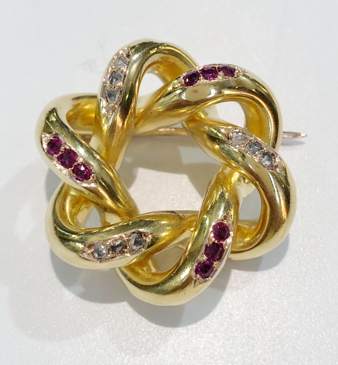 Vintage 18 karat yellow gold brooch designed as a knot, with rubies and diamonds, Italy late 1800s 
Diameter 3cm