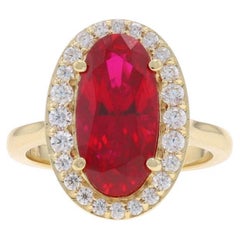 Anillo de oro amarillo con halo de circonitas cúbicas de rubí 14k ovalado 4,26 ctw catedral