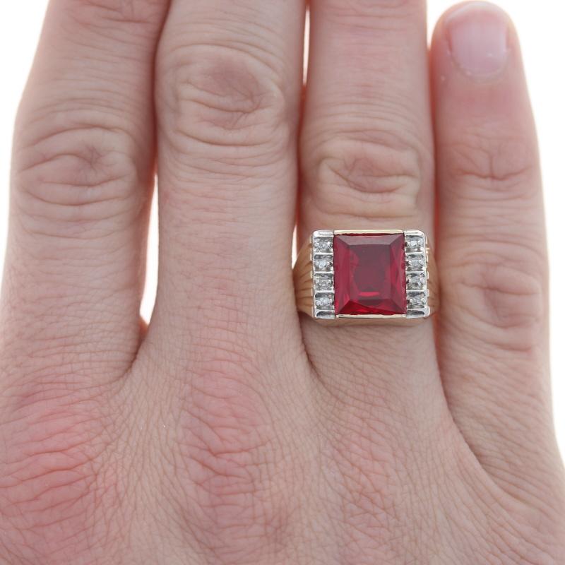 Size: 9 3/4
Sizing Fee: Up 2 sizes for $40 or Down 1 size for $35

Metal Content: 10k Yellow Gold & 10k White Gold

Stone Information
Synthetic Ruby
Carat(s): 6.25ct
Cut: Emerald
Color: Red

Natural Diamonds
Carat(s): .12ctw
Cut: Rough
Color: G -