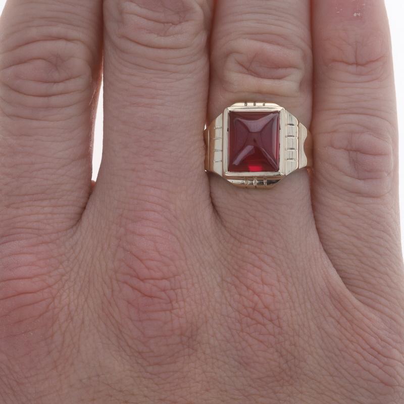 Size: 8 1/4
Sizing Fee: Up 1/2 a size for $35 or Down 1/2 a size for $35

Era: Retro
Date: 1940s - 1950s

Metal Content: 10k Yellow Gold

Stone Information
Synthetic Ruby
Cut: Rectangular Cabochon
Color: Red

Style: Solitaire
Features: Smoothly