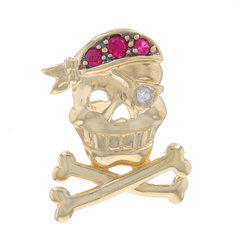 Metal Content: 10k Yellow Gold

Stone Information

Lab Grown Rubies
Treatment: Heating
Carat(s): .09ctw
Cut: Round

Lab Grown White Sapphire
Treatment: Heating
Carat(s): .04ct
Cut: Round

Total Carats: .13ctw

Theme: Jolly Roger,