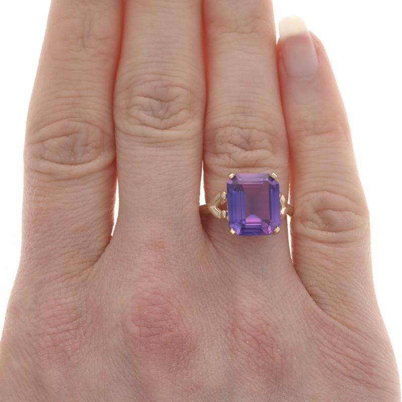 Size: 6
Sizing Fee: Up 2 sizes for $35 or Down 2 sizes for $30

Era: Vintage

Metal Content: 10k Yellow Gold

Stone Information
Synthetic Sapphire
Carat(s): 6.18ct
Cut: Emerald
Color: Purple
Stone Note: Based on the lighting conditions, a color