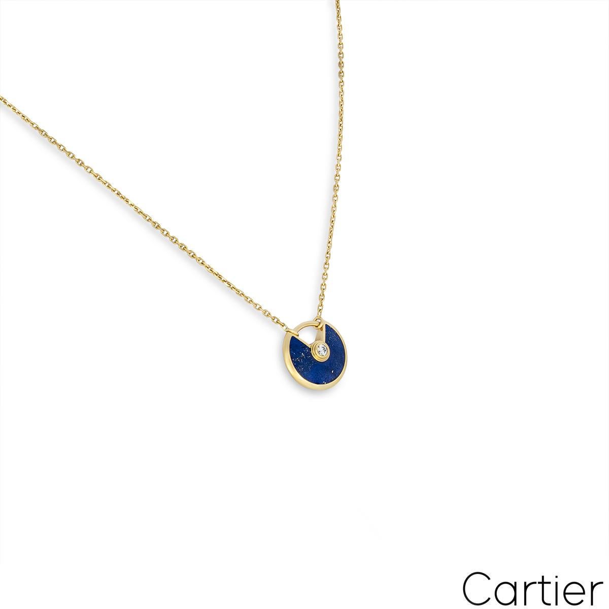 A charming 18k yellow gold lapis and diamond necklace by Cartier from the Amulette de Cartier collection. The XS pendant comprises of a circular talisman set with lapis and complemented by a single round brilliant cut diamonds weighing approximately