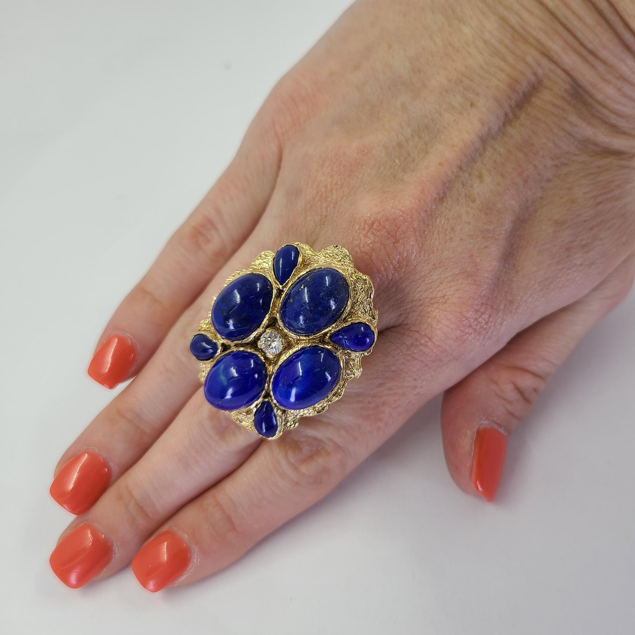 14 Karat Yellow Gold Large Freeform Ring Featuring 8 Cabochon Cut Lapis Lazuli & A 0.25 Carat Round Brilliant Cut Diamond Of VS Clarity & H Color. Finger Size 7.25; Purchase Includes One Sizing Service. Finished Weight Is 27.8 Grams.