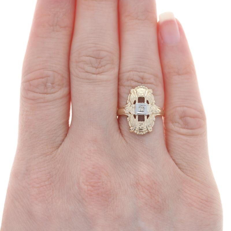 Size: 5 1/4
Sizing Fee: Down 2 for $30 or up 2 for $35

Era: Art Deco
Date: 1920s - 1930s

Metal Content: 14k Yellow Gold & 14k White Gold

Stone Information

Natural Diamond
Carat(s): .03ct
Cut: Single
Color: N, Light Brown
Clarity: VS1

Style: