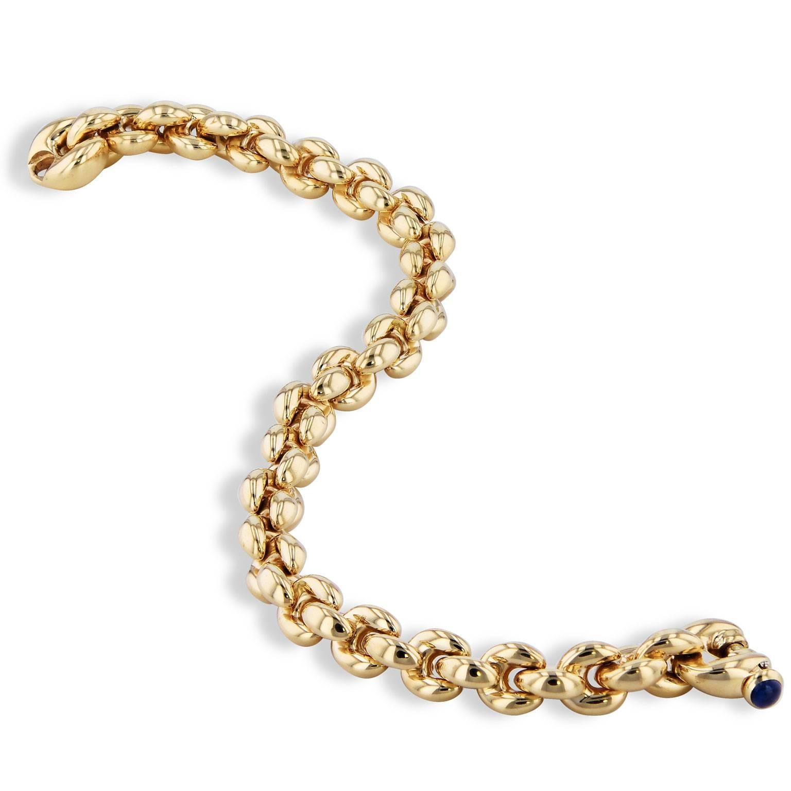 Enjoy this previously loved 18 karat yellow gold link bracelet with a sapphire cabochon clasp. Make it your new favorite accessory.