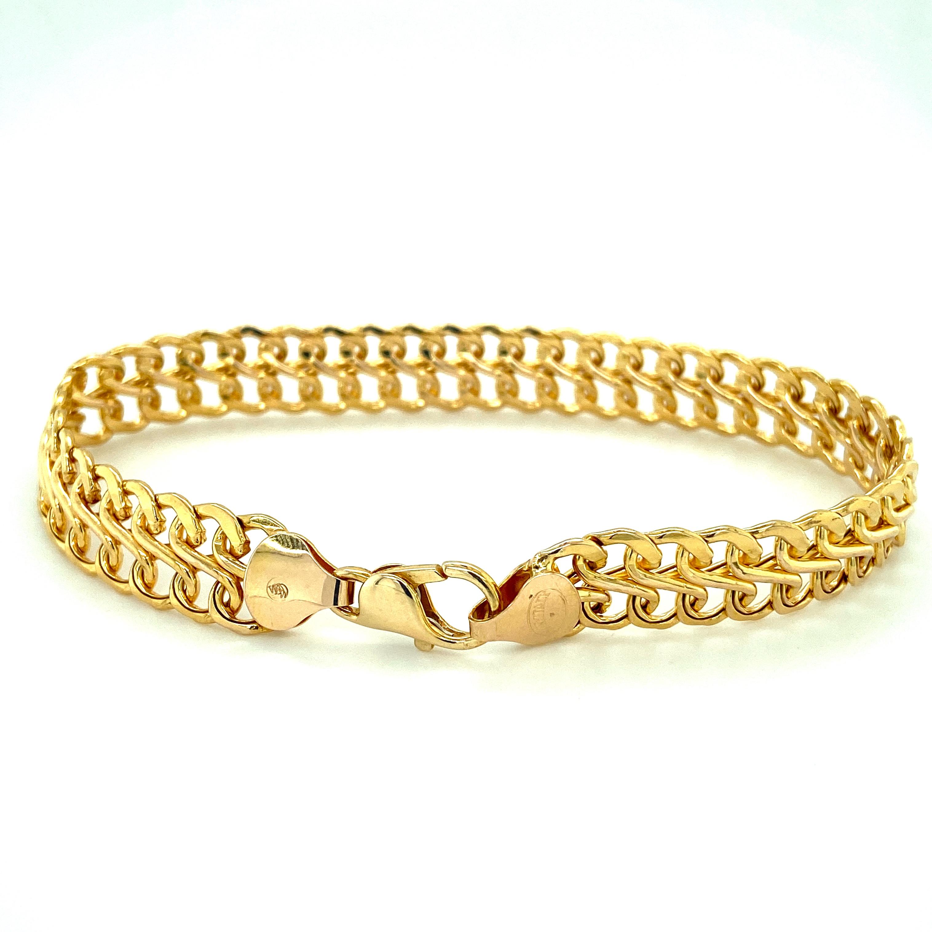 One 14 karat yellow gold (stamped 14K ITALY) double row s-link mesh bracelet measuring 10.5mm wide and 7.75 inches long.  


