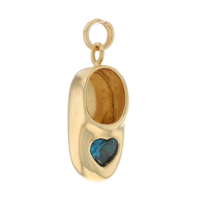 Metal Content: 14k Yellow Gold

Stone Information
Natural Topaz
Treatment: Routinely Enhanced
Cut: Heart
Color: London Blue

Style: Solitaire
Theme: Child's Shoe, Mother's Infant Toddler Birth Month Keepsake

Measurements
Tall (from stationary