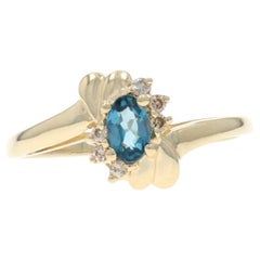 Yellow Gold London Blue Topaz Diamond Bypass Ring - 10k Oval .32ctw