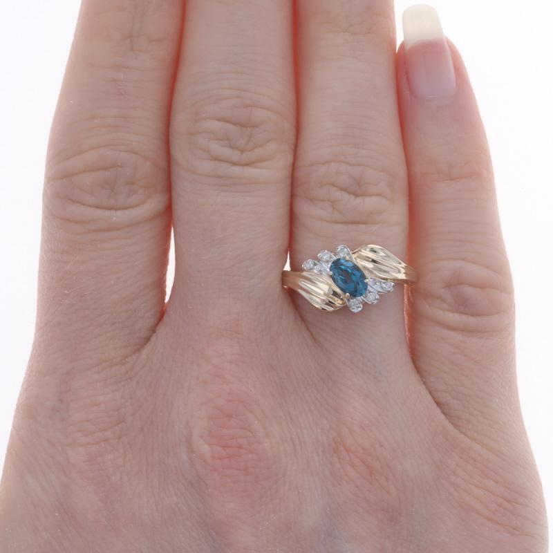 Size: 5 3/4
Sizing Fee: Up 2 sizes for $35 or Down 2 sizes for $30

Metal Content: 14k Yellow Gold & 14k White Gold

Stone Information
Natural Topaz
Treatment: Routinely Enhanced
Carat(s): .70ct
Cut: Oval
Color: London Blue

Natural