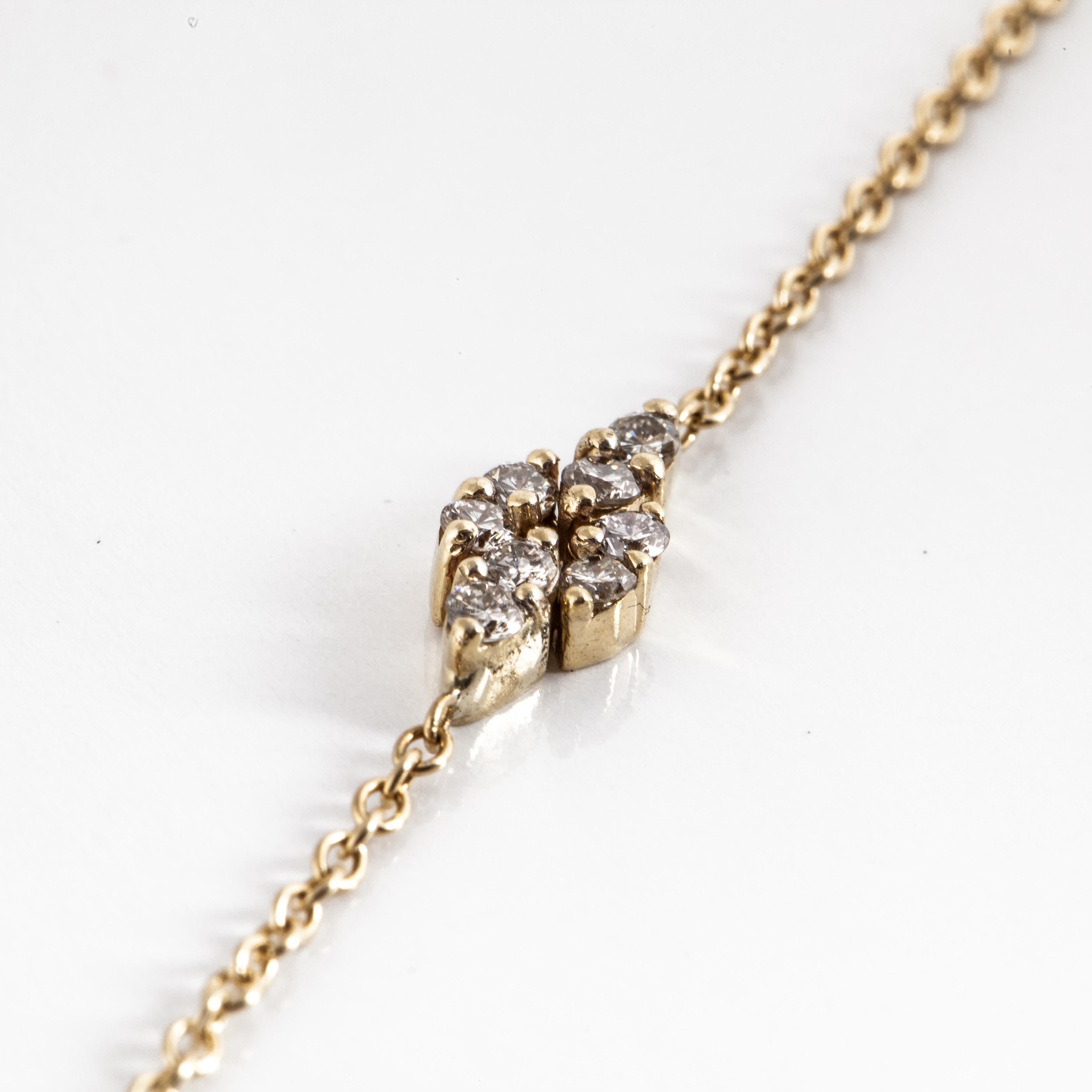 18K yellow gold thin chain with diamond stations.  Each station measures 3/8 inches long and 1/4 inch wide.  There are a total of 176 round brilliant-cut diamonds that total 6.10 carats; G-H color, VS12-VS2 clarity.  The chain measures 44 inches in