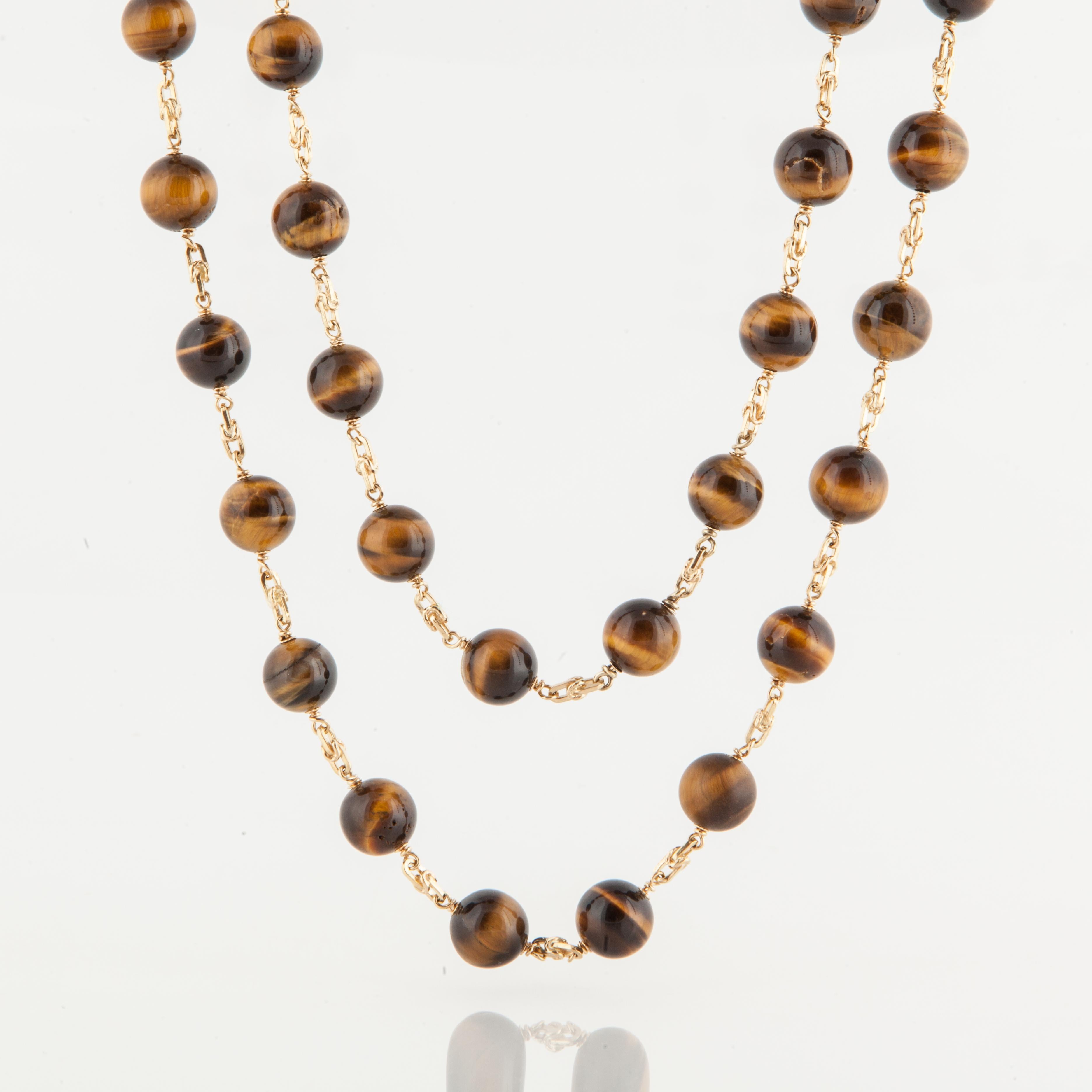 Tiger's Eye bead and chain necklace composed of 111 beads that are slightly graduated and 18K yellow gold.  The beads are measure 9.6mm - 15mm.  The necklace measures 102 1/2 inches long.  