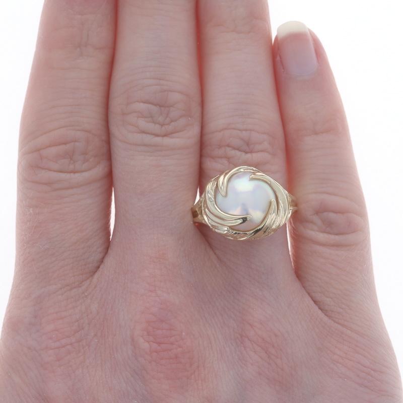 Size: 9
Sizing Fee: Up 3 sizes for $35 or Down 3 sizes for $25

Metal Content: 10k Yellow Gold

Stone Information
Natural Mabe Pearl

Style: Cocktail Solitaire
Theme: Swirl Wave

Measurements
Face Height (north to south): 9/16