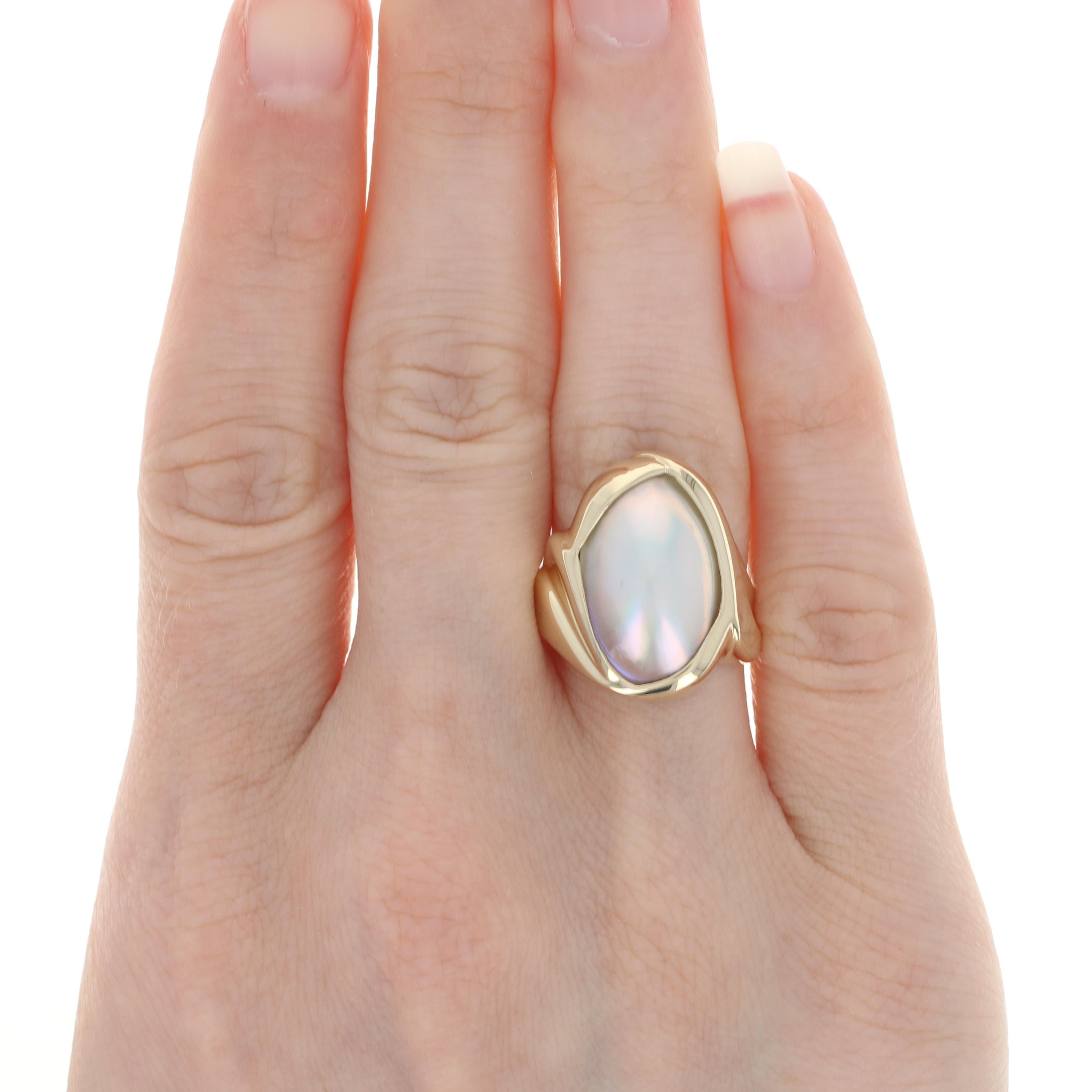 Size: 7 1/4
Sizing Fee: Can be sized up or down 1 size for $30

Metal Content: 14k Yellow Gold

Stone Information: 
Genuine Mabe Pearl

Style: Cocktail Solitaire / Bypass

Face Height (north to south): 27/32