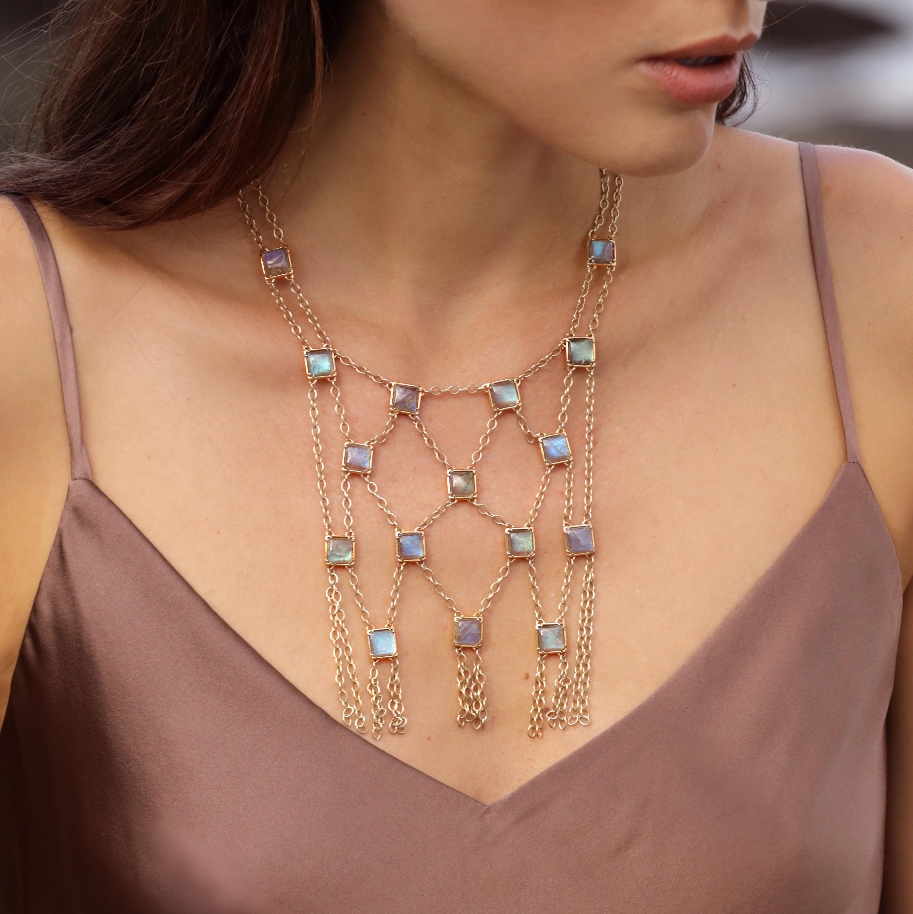 The glowing blue labradorite on open work mesh chain is designed strategically to function casually or as a bold standout.  
Whether on the skin or over a garment, this alluring yellow gold bib necklace is a versatile layer added to a keenly edited