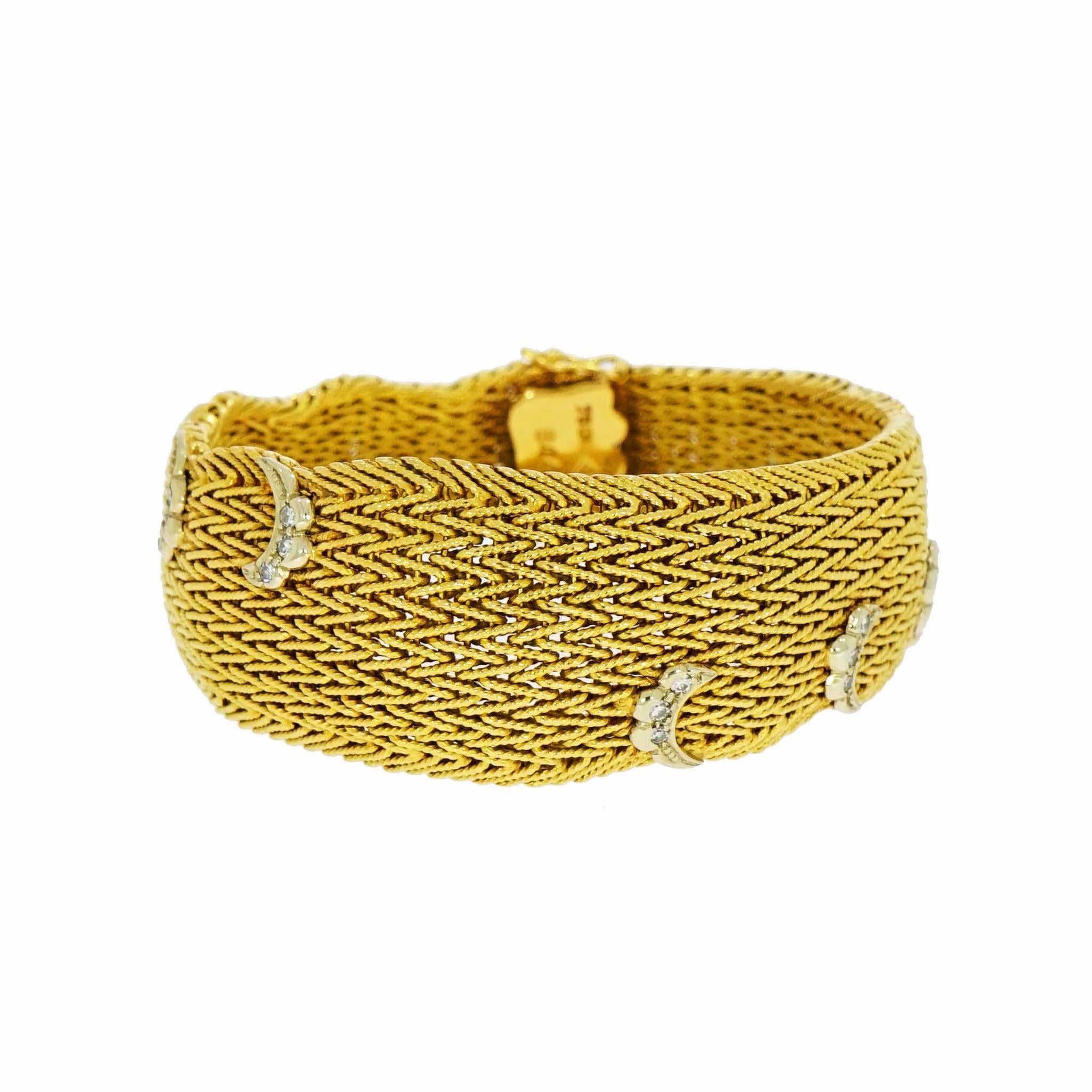 Handcrafted in Italy, a Yellow gold weaved mesh bracelet. Circa 1950-60's, and adorned with 6 white gold swirls with 3 Round Diamonds each.
Measures 7 inches in length and 35mm in width tapering down to 16mm, is marked 750 for 18K gold.
