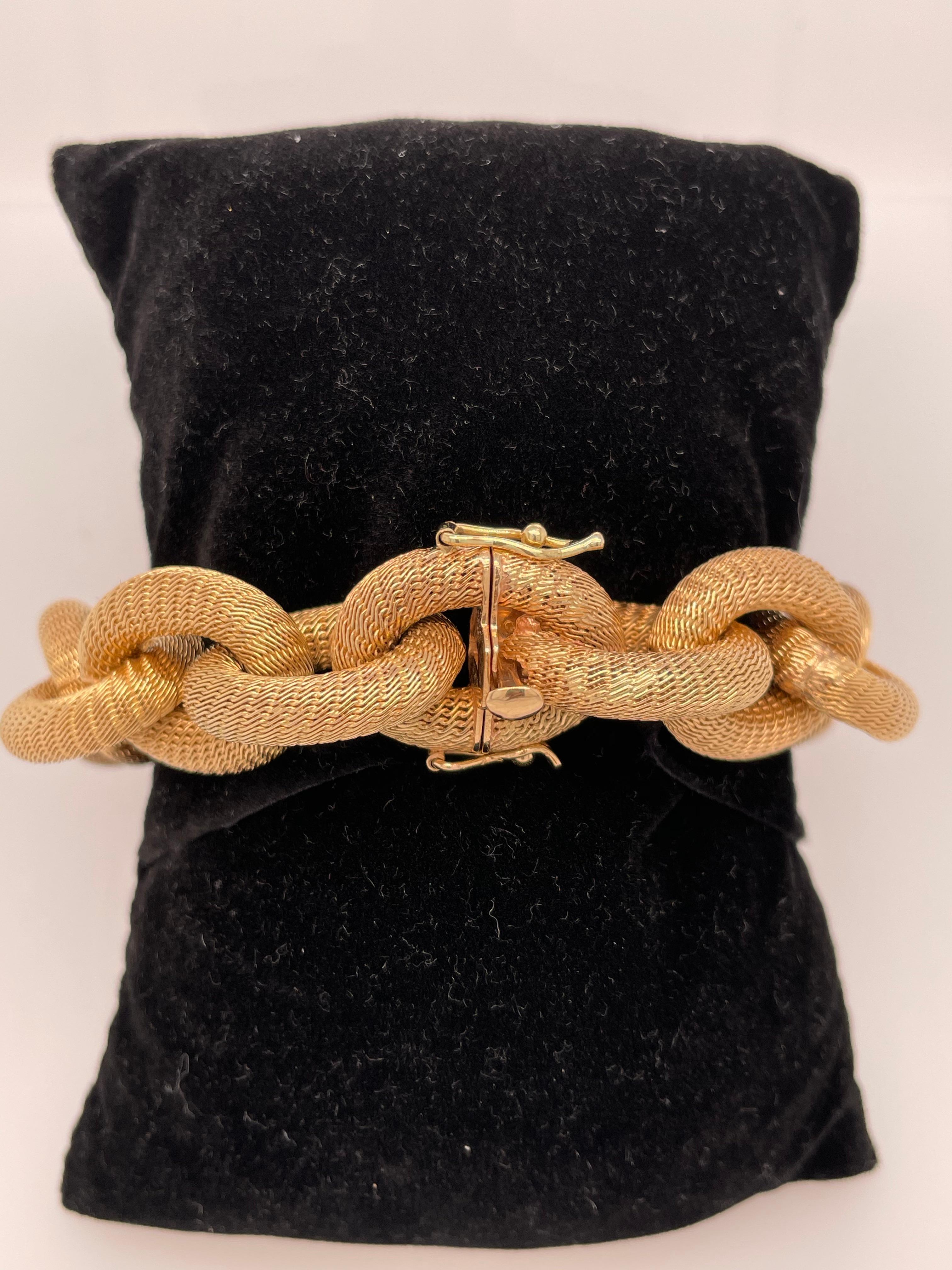 Exceptionally made Italian yellow gold link bracelet.  This bracelet is 18K yellow gold, compromised of interlocking woven mesh oval links. This statement piece has somewhat of a matte finish to it. This fine piece is an everyday staple to any