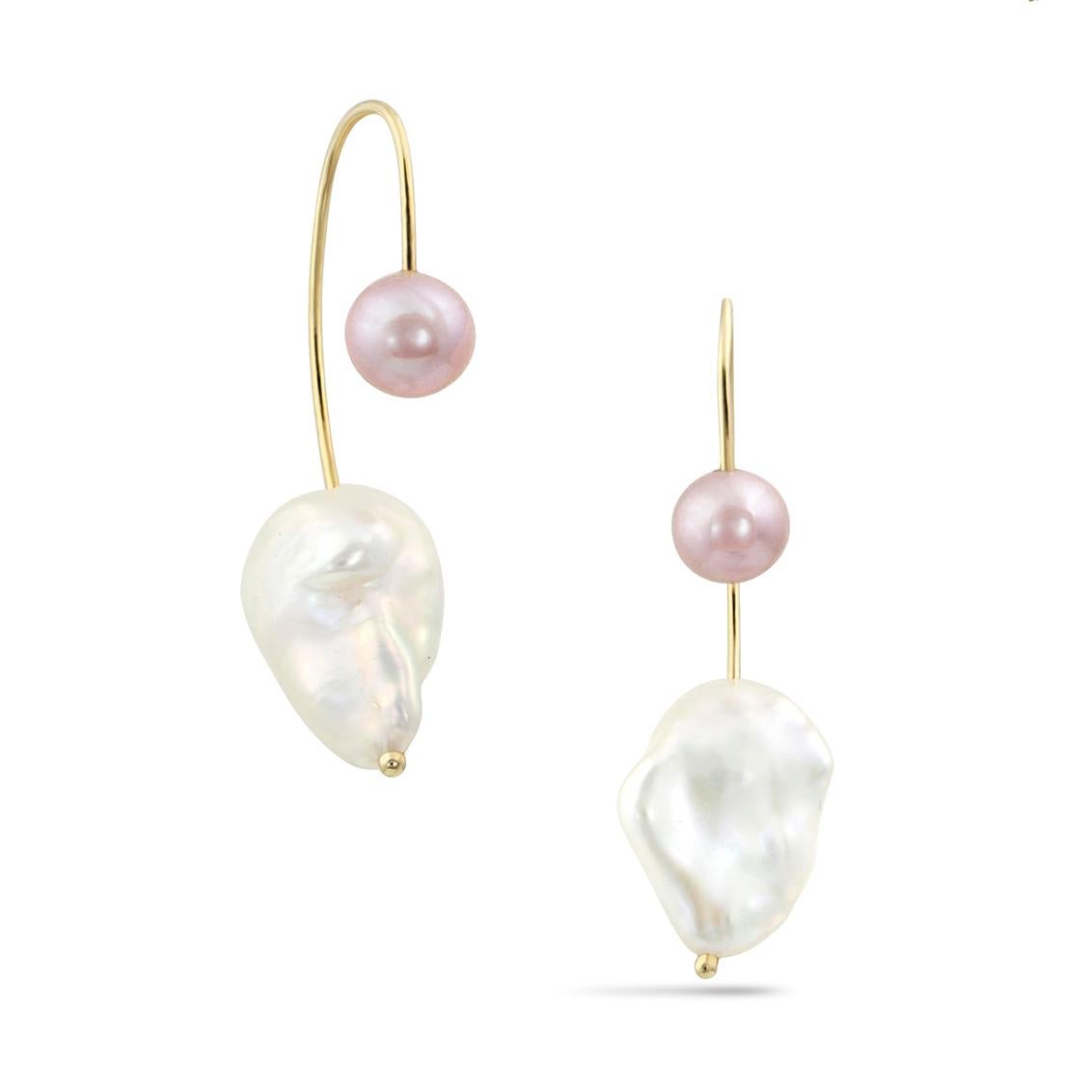 Elegantly carved by nature, a beautifully organic baroque pearl descends from behind the ear, suspended by a contrasting recycled solid gold curve and round pearl.  The classic round pearl plays beautifully against the baroque pearl, creating a