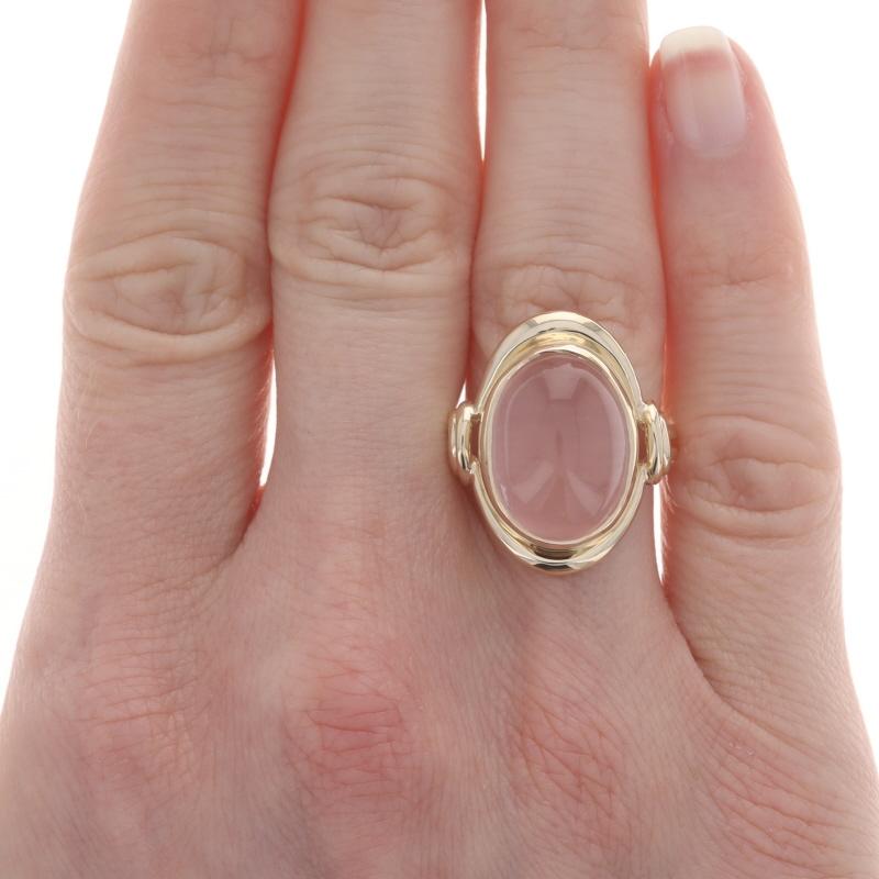 Size: 7 1/4
Sizing Fee: Up 1 size for $50

Note: The re-sizing process will remove the interior stamps.

Metal Content: 14k Yellow Gold

Stone Information

Natural Moonstone
Carat(s): 9.20ct
Cut: Oval Cabochon
Color: Light Pink

Total Carats: