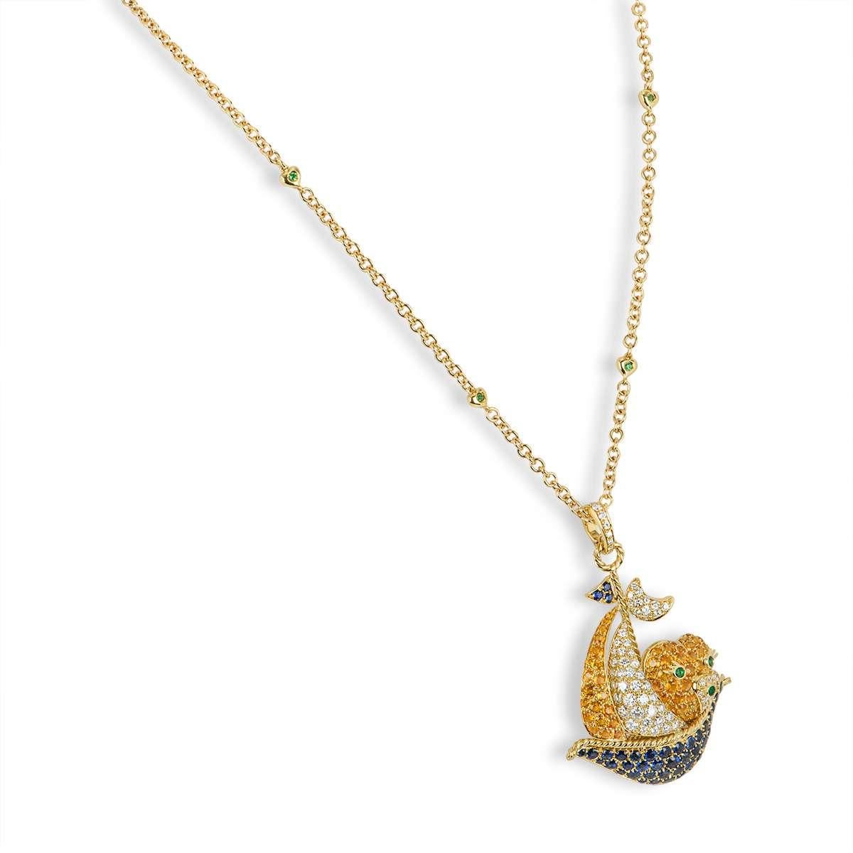 An 18k yellow gold sapphire, emerald and diamond pendant. The pendant features a large sailing boat motif, set with emeralds, diamonds and orange and blue sapphires. The diamonds have a total weight of approximately 1.98ct, the orange and blue