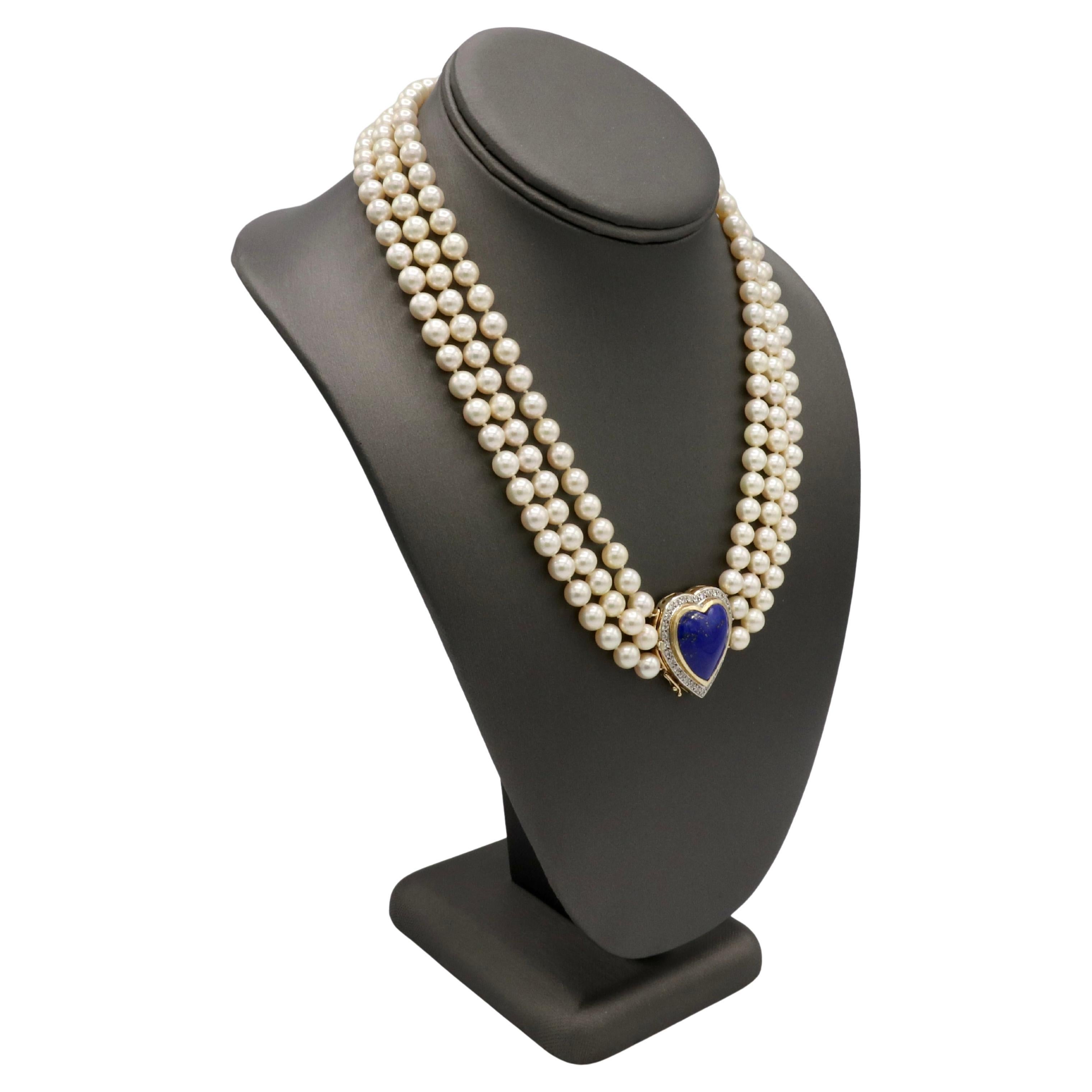 14 Karat Yellow Gold Three-Strand Cultured Pearl, Diamond & Lapis Lazuli Heart Necklace

Metal: 14k yellow gold
Weight: 96 grams
Pearls: 7mm round cultured pearls
Clasp: 26 x 30mm heart
Diamonds: Approx. 0.50 CTW H-I VS round natural