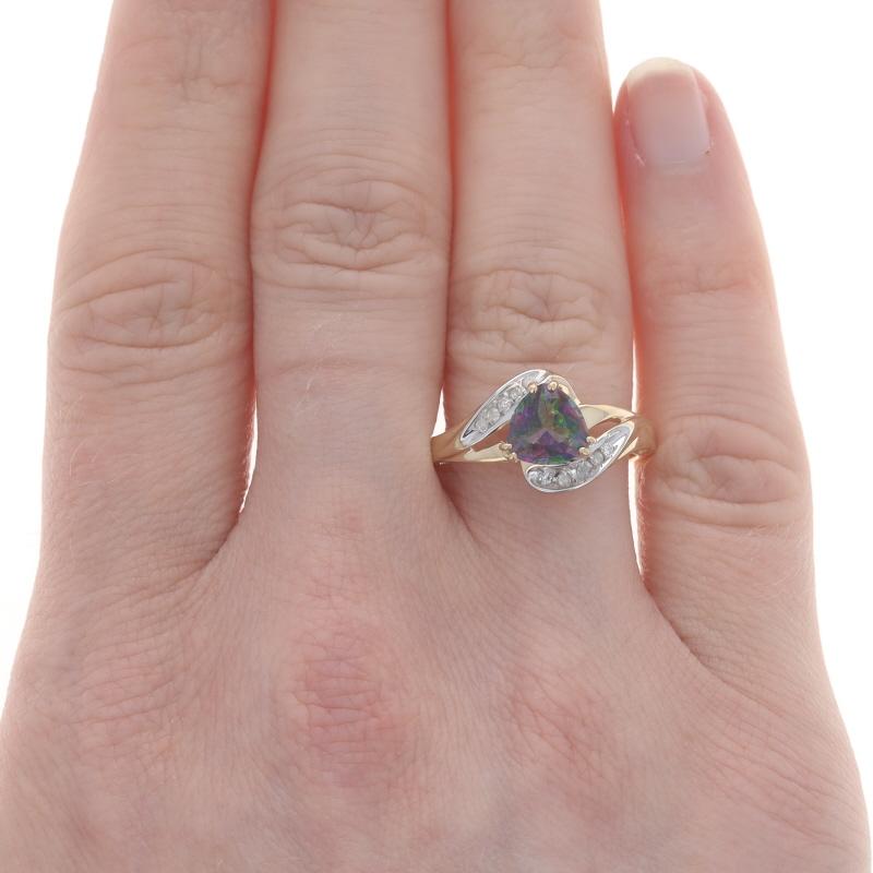Size: 7
Sizing Fee: Up 2 sizes for $30 or Down 1/2 a size for $30

Metal Content: 10k Yellow Gold & 10k White Gold

Stone Information

Natural Mystic Topaz
Treatment: Coating
Carat(s): 1.16ct
Cut: Trillion

Natural Diamonds
Carat(s): .06ctw
Cut: