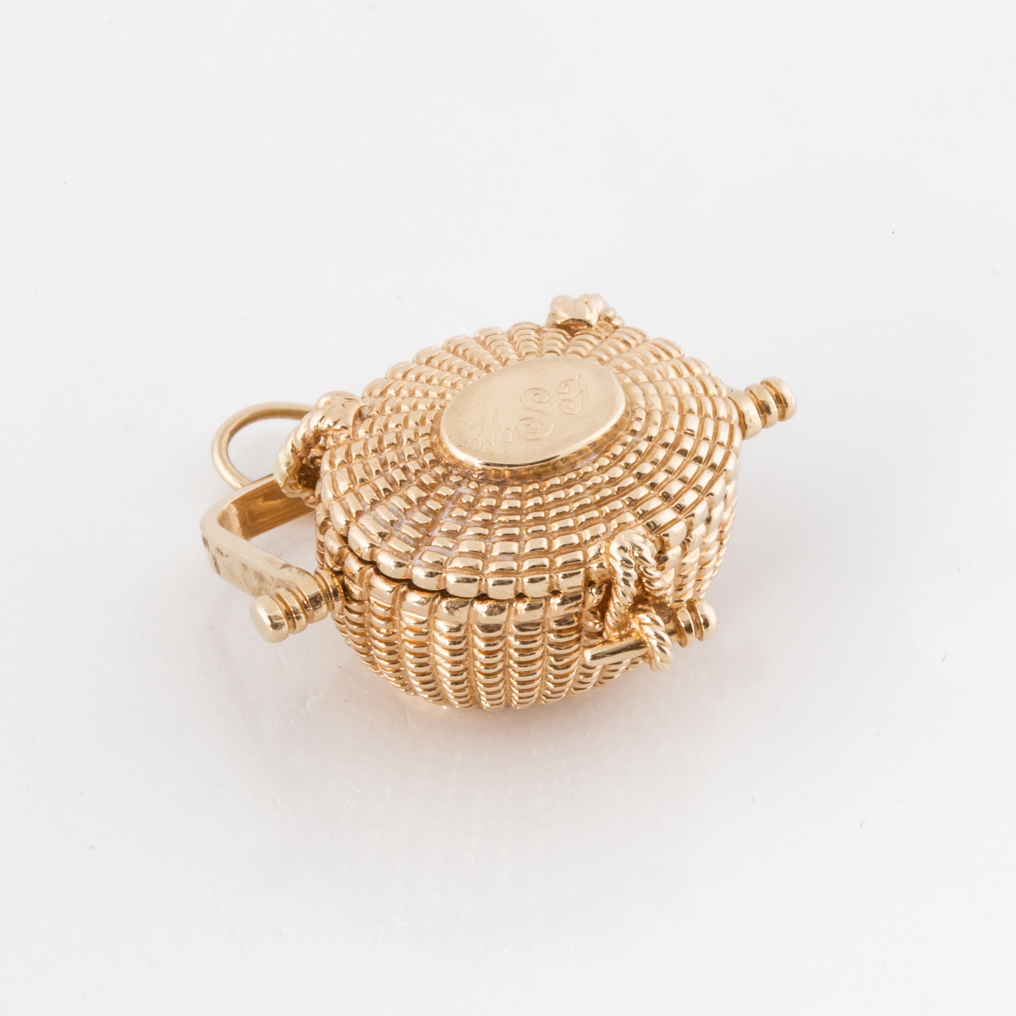 14K yellow gold Nantucket basket charm or pendant.  Opens to reveal a miniature penny still inside.  Dated 1977 with other engraving.  Measures 1-1/8