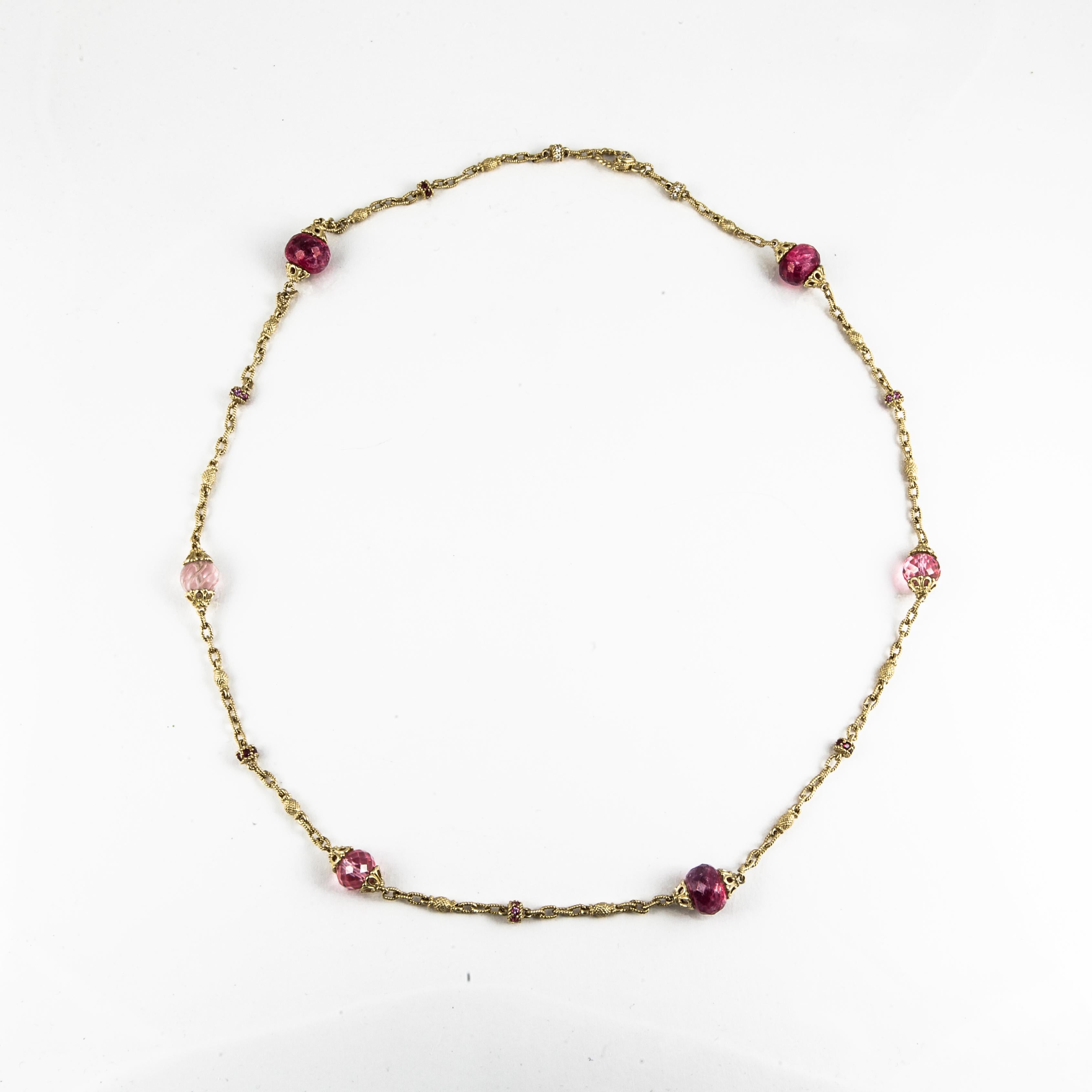 18K yellow gold link station necklace with ruby and rose quartz beads accented by round diamonds and pink sapphires. There are 15 round diamonds that total 0.15 carats, 36 pink sapphires, 3 ruby beads and 3 rose quartz beads.  Necklace measures 29