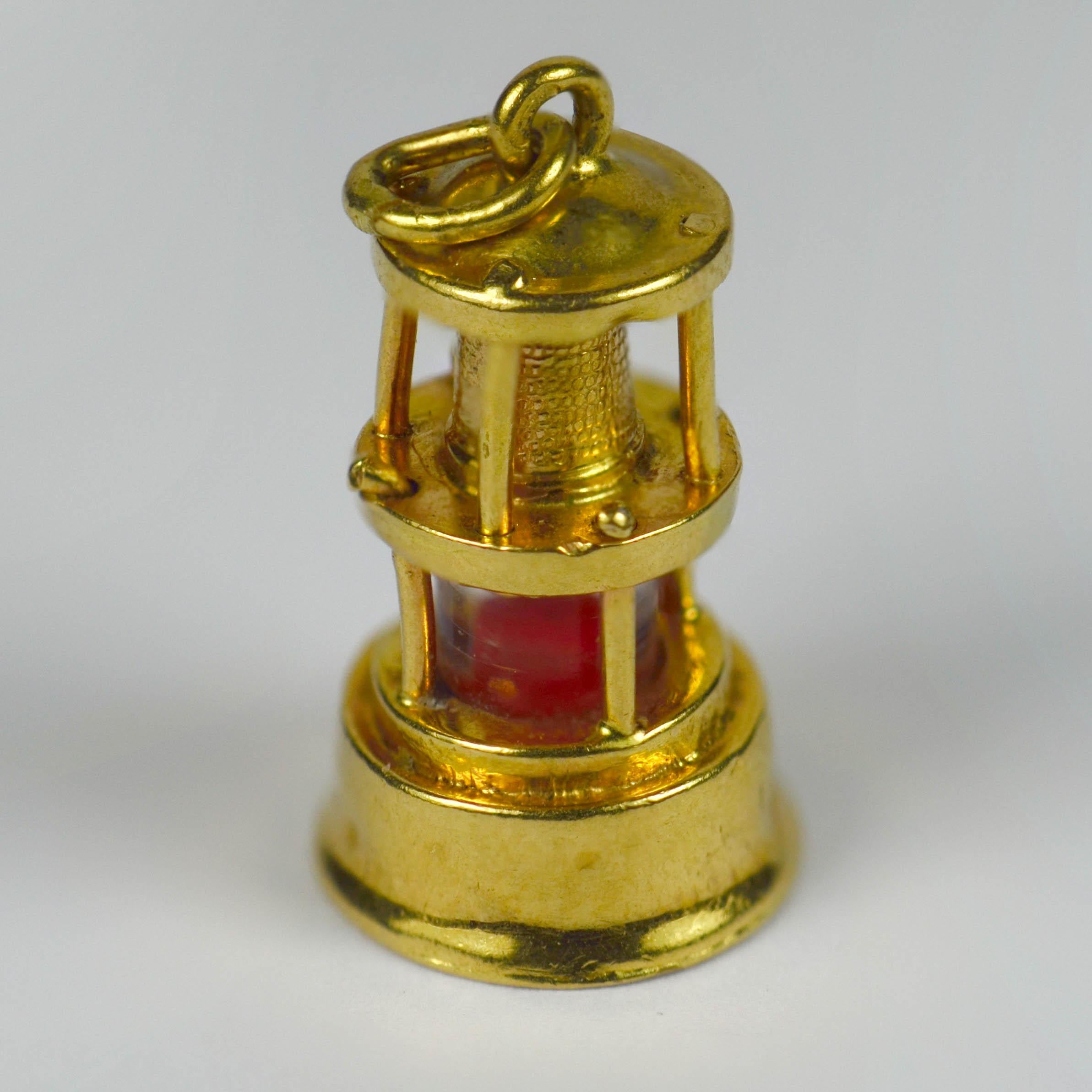 An 18 karat yellow gold charm pendant designed as a traditional oil lantern or lamp, the flame of the light indicated by coloured plastic. Stamped with the owl poincon for French import of 18 karat gold.

Dimensions: 2 x 0.9 x 0.9 cm
Weight: 1.28