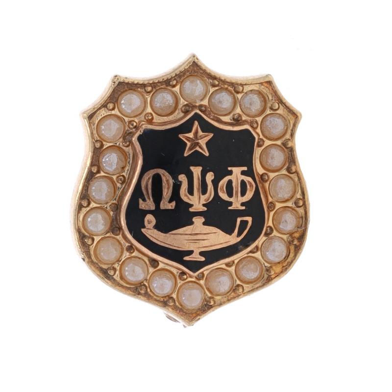 Brand: Balfour
Fraternity: Omega Psi Phi
Fraternity Founding Date: 1911
Chapter: Xi Upsilon (graduate chapter)
Chapter Founding Date: 1952
Date: 1961

Metal Content: 10k Yellow Gold

Stone Information
Seed Pearls

Material Information
Enamel
Color: