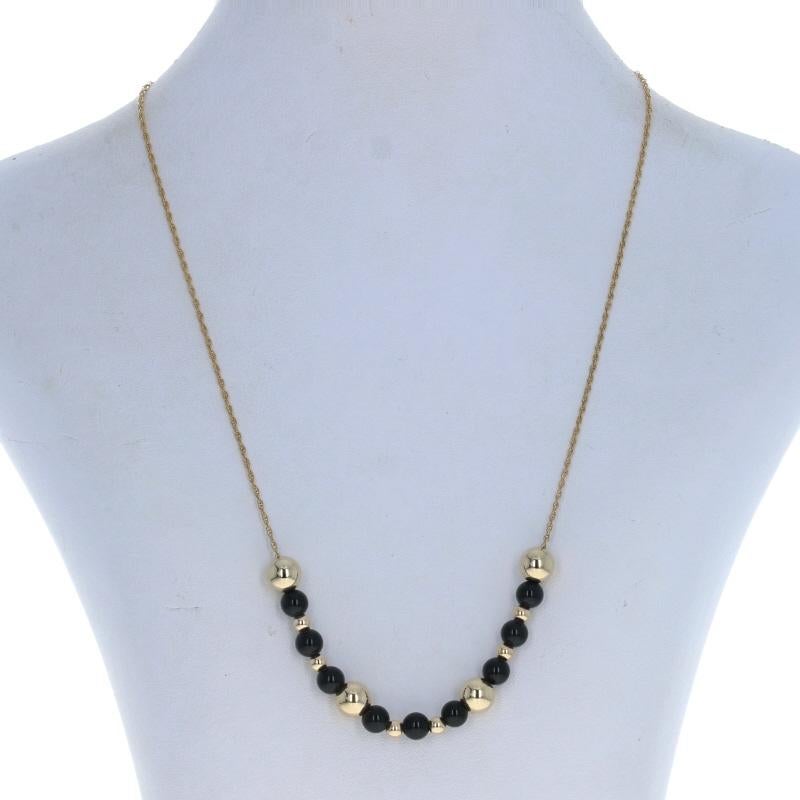 Metal Content: 14k Yellow Gold

Stone Information
Natural Onyx
Color: Black
Diameter: 6mm

Chain Style: Prince of Wales
Necklace Style: Beaded Chain
Fastening Type: Spring Ring Clasp

Measurements
Length: 18 1/4
