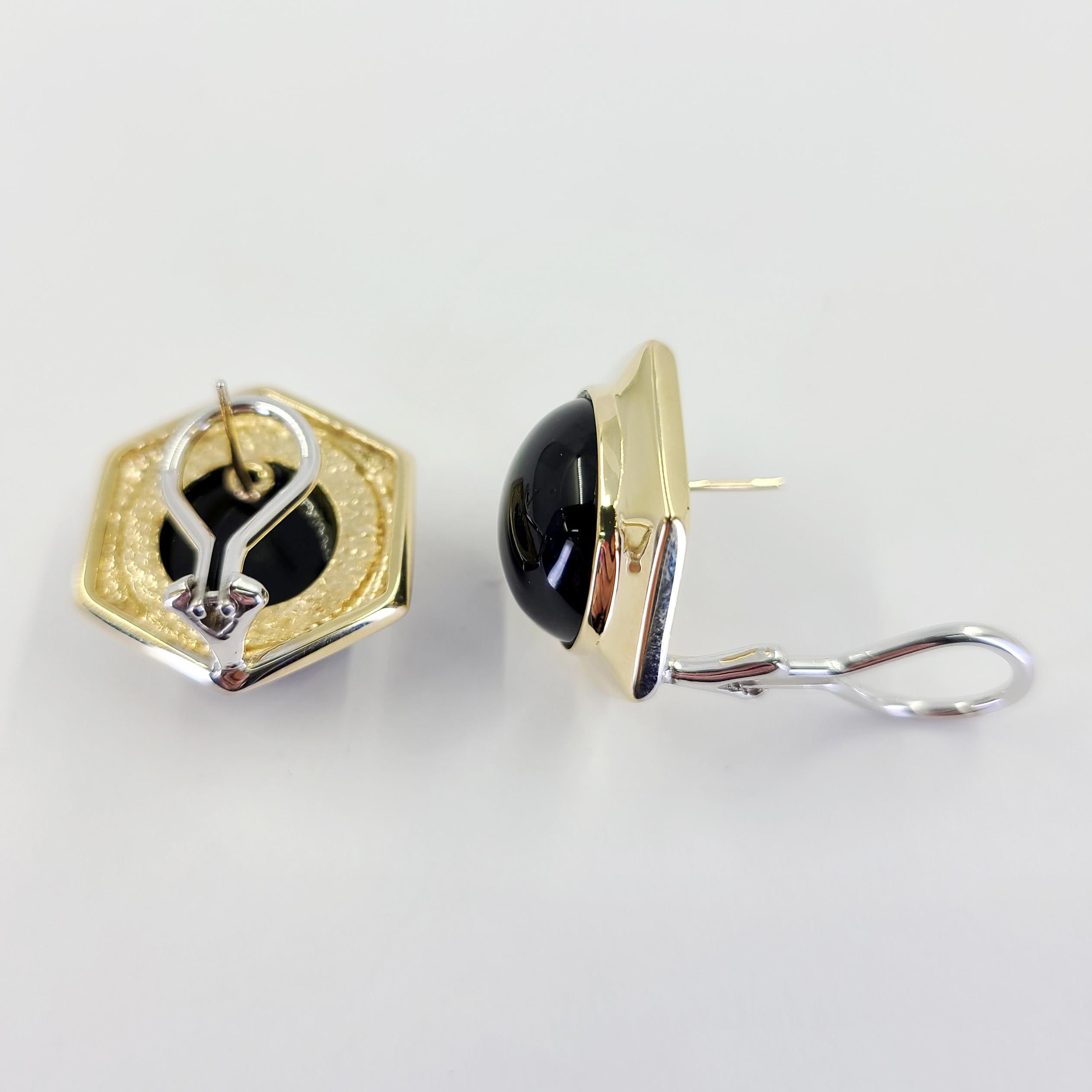 14 Karat Yellow Gold Hexagonal Earrings Featuring 2 Bezel Set 14mm Round Cabochon Onyx. Pierced Post With 14 Karat White Gold Omega Clip Back. Finished Weight Is 14.5 Grams.