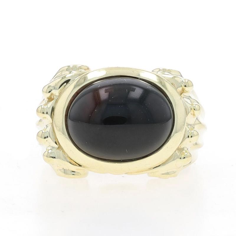 Size: 7 1/4
Sizing Fee: Up 1 size for $35 or Down 1 size for $35

Metal Content: 14k Yellow Gold

Stone Information

Natural Onyx
Cut: Oval Cabochon
Color: Black

Style: Cocktail Solitaire
Theme: Scroll Motif
Features: East-West Set
