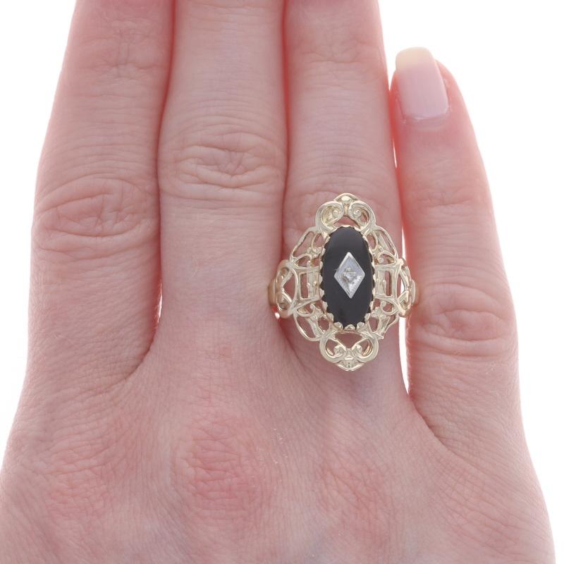 Size: 10 1/4
Sizing Fee: Up 3 sizes for $30 or Down 2 sizes for $30

Metal Content: 10k Yellow Gold & 10k White Gold

Stone Information

Natural Onyx
Color: Black

Natural Diamond
Cut: Single
Stone Note: (one small accent)

Style: Solitaire with