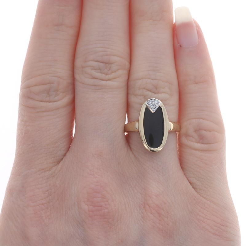 Size: 5 1/2
Sizing Fee: Up 1/2 a size for $30 or Down 1/2 a size for $30

Metal Content: 14k Yellow Gold & 14k White Gold

Stone Information
Natural Onyx
Color: Black

Natural Diamonds
Carat(s): .06ctw
Cut: Round Brilliant
Color: I - J
Clarity: SI2