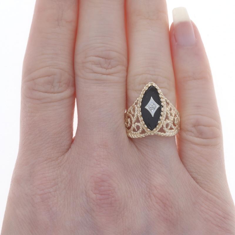 Size: 7
Sizing Fee: Up 2 1/2 sizes for $35 or Down 2 sizes for $30

Metal Content: 14k Yellow Gold & 14k White Gold

Stone Information

Natural Onyx
Cut: Marquise Cabochon
Color: Black

Natural Diamond
Cut: Single
Stone Note: (one small