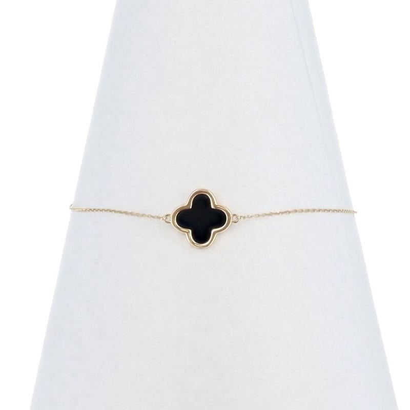 Metal Content: 14k Yellow Gold

Stone Information
Natural Onyx
Color: Black

Style: Chain Station
Chain Style: Diamond Cut Cable
Bracelet Style: Chain Station
Fastening Type: Lobster Claw Clasp
Theme: Quatrefoil, Flower

Measurements
Adjustable